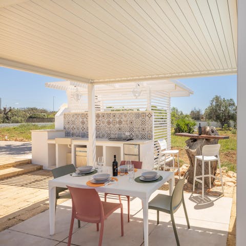Whip up an afternoon meal at the outdoor kitchen and enjoy around the table