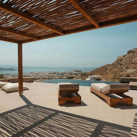 Savour views of the Aegean Sea as you relax on the poolside