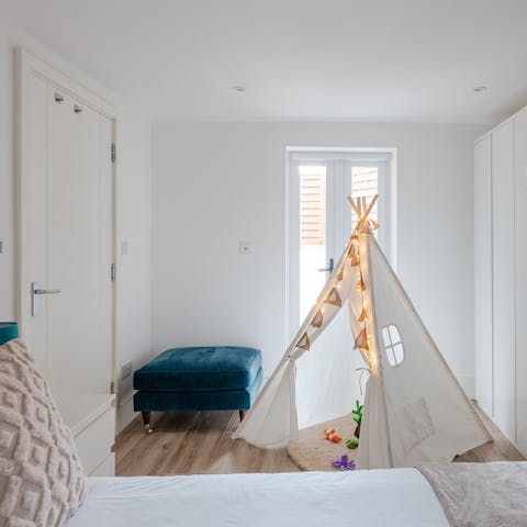 Keep one eye on the kids playing in the teepee tent next to your bed