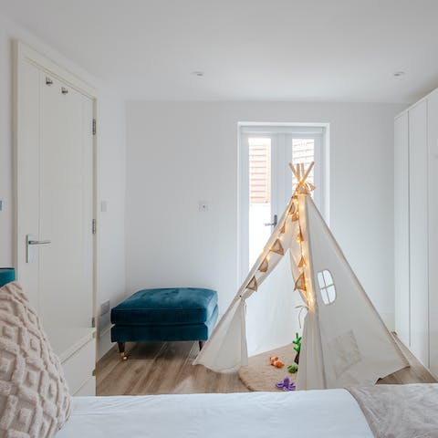 Keep one eye on the kids playing in the teepee tent next to your bed