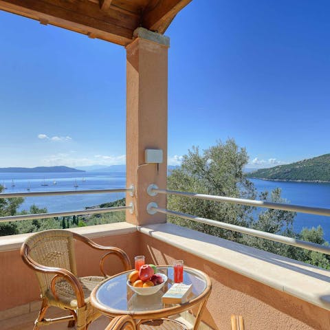Watch the yachts bob across the waves from the private balcony