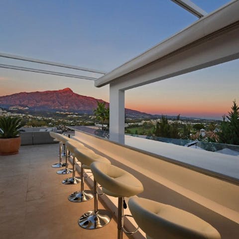 Head up to the roof terrace at sunset and whip up delicious cocktails at the bar