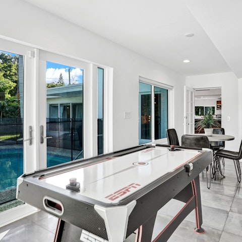 Play a game of air hockey with stunning views of the garden in the background