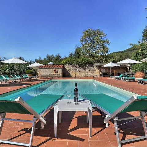 Relax in the Tuscan sun by the shared pool