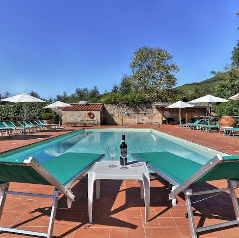 Relax in the Tuscan sun by the shared pool