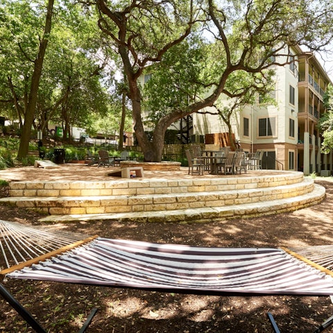 Unwind in the dappled shade with a book in the hammock in the communal garden
