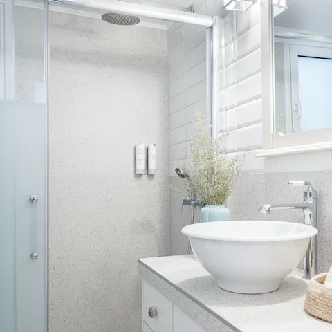 Start mornings with a relaxing soak under the bathroom's rainfall shower