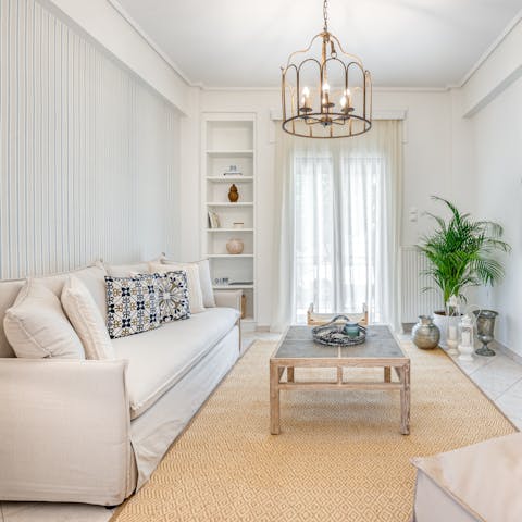 Kick back in the bright living room with a glass of wine after a day of touring the city