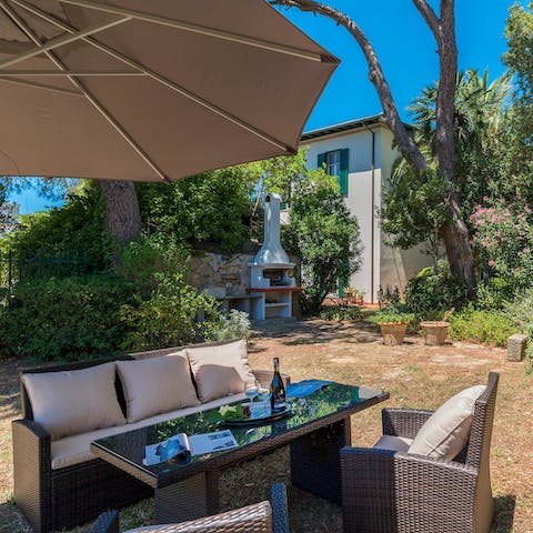 Feast on barbecued delights under the parasol in the garden