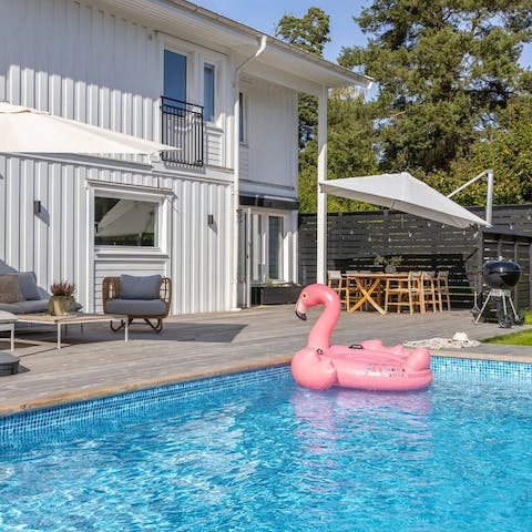 Bask in the sun with a good book before taking a dip in the swimming pool