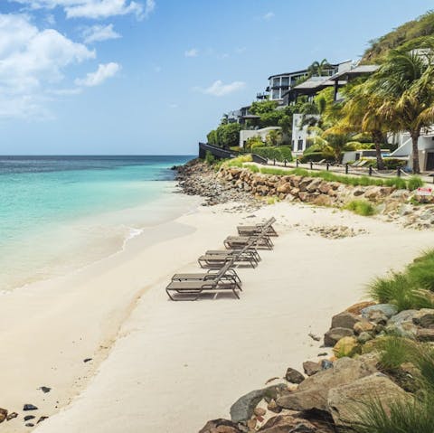 Relax on soft white sands just moments from your villa