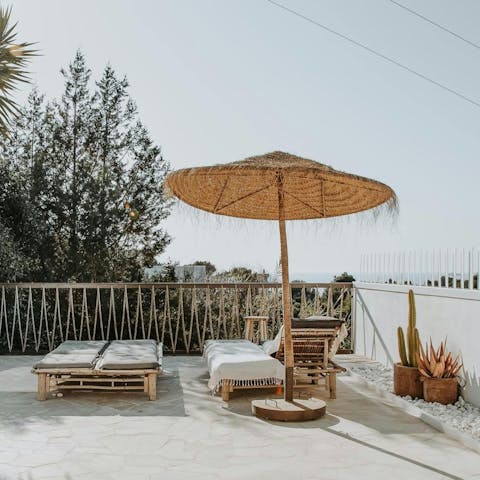 Relax with a cocktail and admire the distant sea views