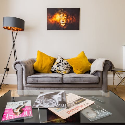 Kick back and relax on the sofa in the light-filled living room 