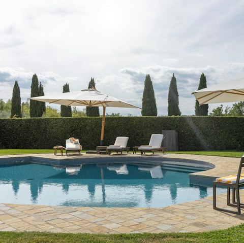 Jump into the communal swimming pool before soaking up the sunshine on a lounger