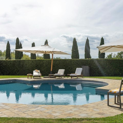 Jump into the communal swimming pool before soaking up the sunshine on a lounger