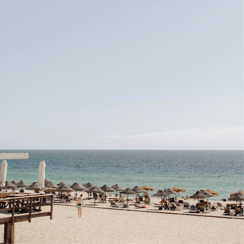 Sink your toes into the sands of Carvalhal Beach, a short drive away