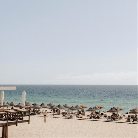 Sink your toes into the sands of Carvalhal Beach, a short drive away