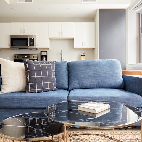 Relax in style with a book off the marble-topped coffee table