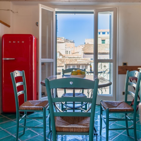 Enjoy a glass of Sicilian wine in the kitchen
