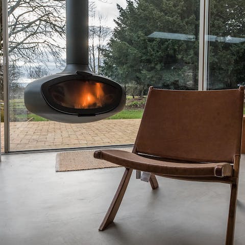 Relax by the modern hanging wood burner in the sleek extension