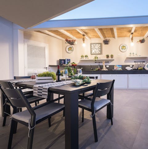 Gather around the outdoor dining table for an evening of relaxed dinners, drinks, and card games