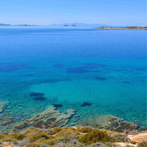 Take a refreshing dip at Parasporos Beach, just a six-minute drive away