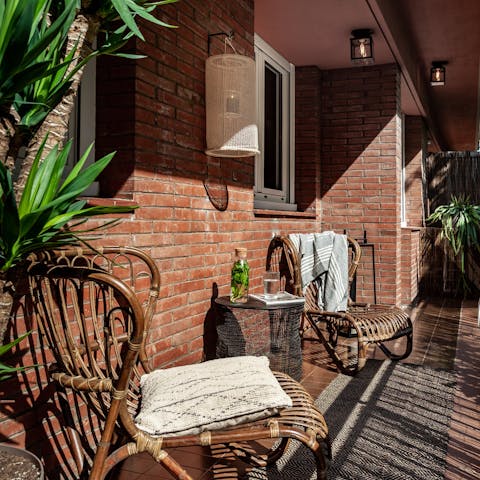 Catch some sun on the balcony's wicker chairs