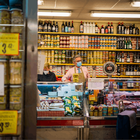 Visit the vibrant indoor market, Mercado Antón Martín, a short walk away