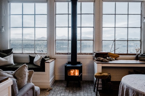 Warm up by the wood-burning stove as mist rolls over the harbour