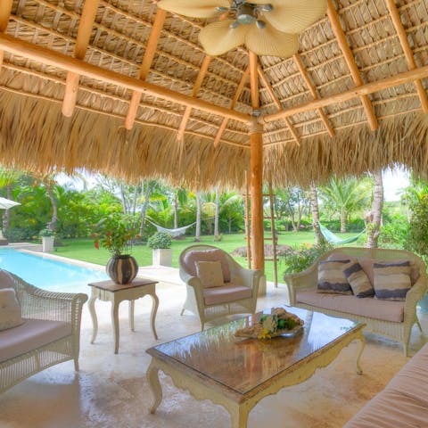 Sip happy hour cocktails under the cabana