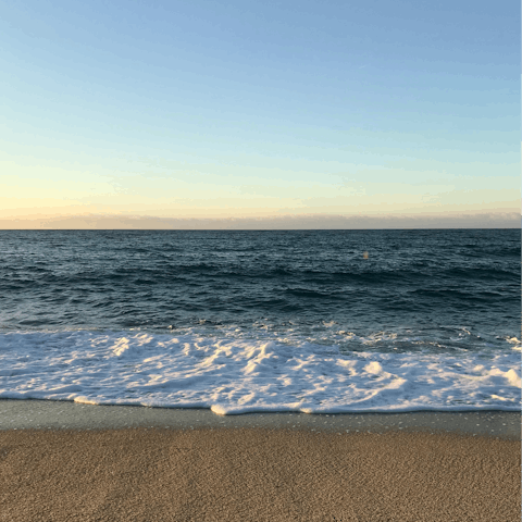 Stroll along the pebbles of Platja de la Grava, a short drive away