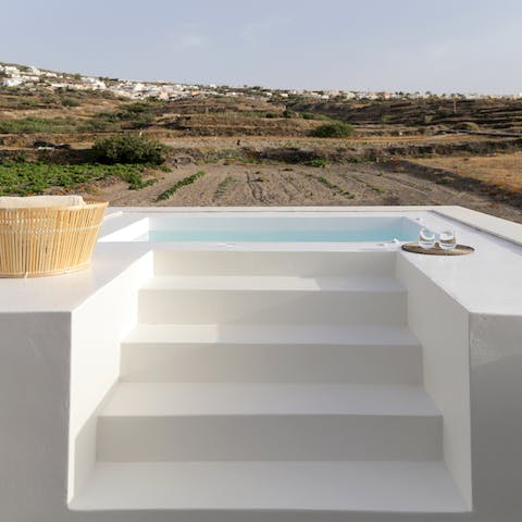 Step up to the hot tub and look out toward the vineyards