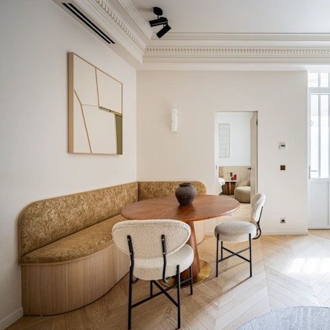 Gather around the curved dining nook in this elegant Paris apartment