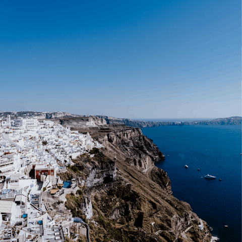 Weave through the whitewashed houses of Thera, 3km away