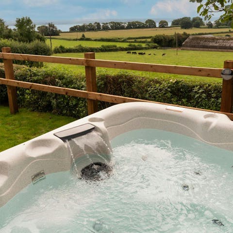 Soak in the private hot tub and take in the views