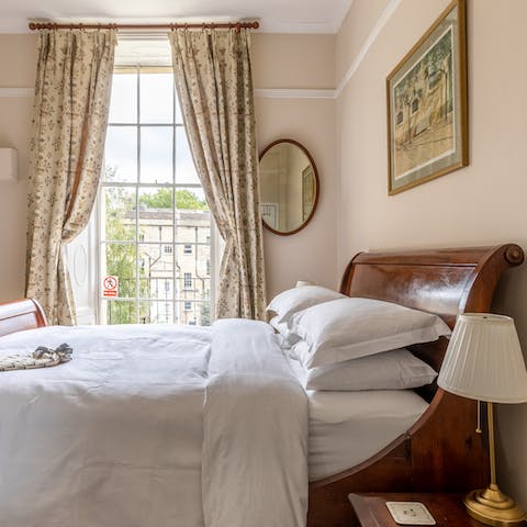 Drift off to sleep in the elegant mahogany sleigh bed