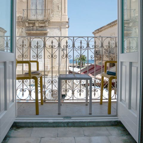 Sip a sundowner on the private balcony while people-watching from your privileged position