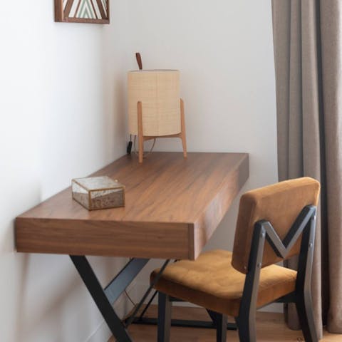 Catch up on work at the bedroom's chic desk space