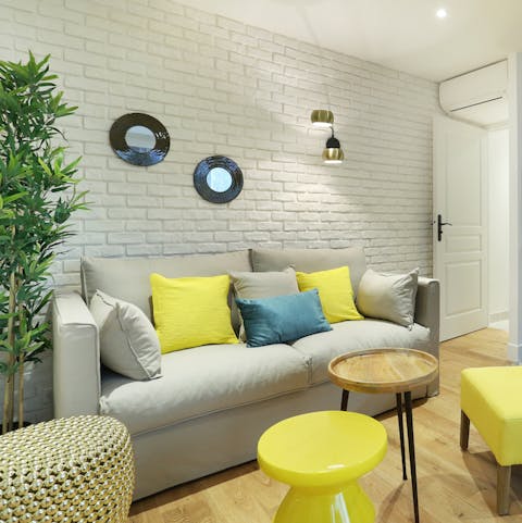 Relax on the plum sofa after a long day of exploring Paris