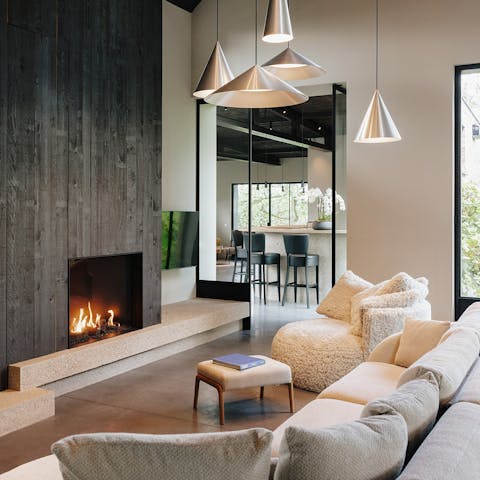 Cosy up in front of the fireplace in the striking living room