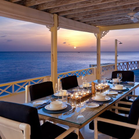 Dine alfresco while the sun sets over the sea