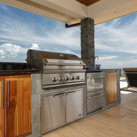 Grill up a feast in the full outdoor kitchen and serve in the shade
