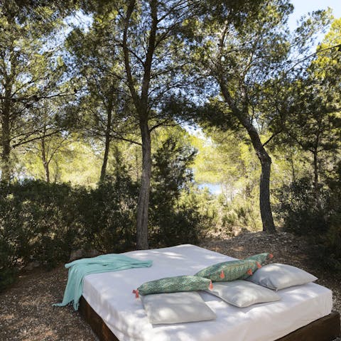Take a well-earned siesta in the shade of the trees on the day bed