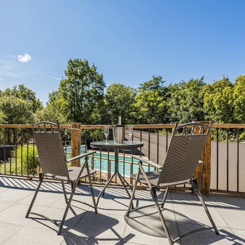 Toast the day with a glass of local wine on the balcony