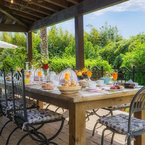 Gather together for a barbecue feast under the pergola