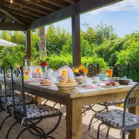 Gather together for a barbecue feast under the pergola