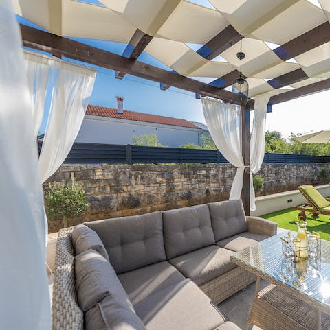 Settle down on the outdoor sofa and indulge in a good book