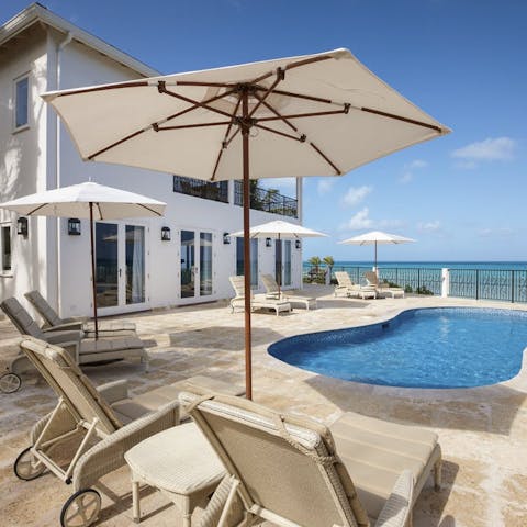 Lounge around your own private pool with a sea view
