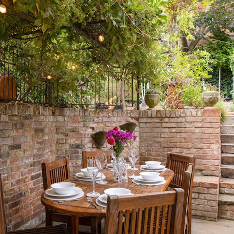 Lay the table for atmospheric alfresco meals in the charming walled garden