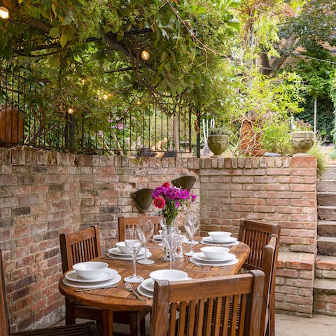Lay the table for atmospheric alfresco meals in the charming walled garden